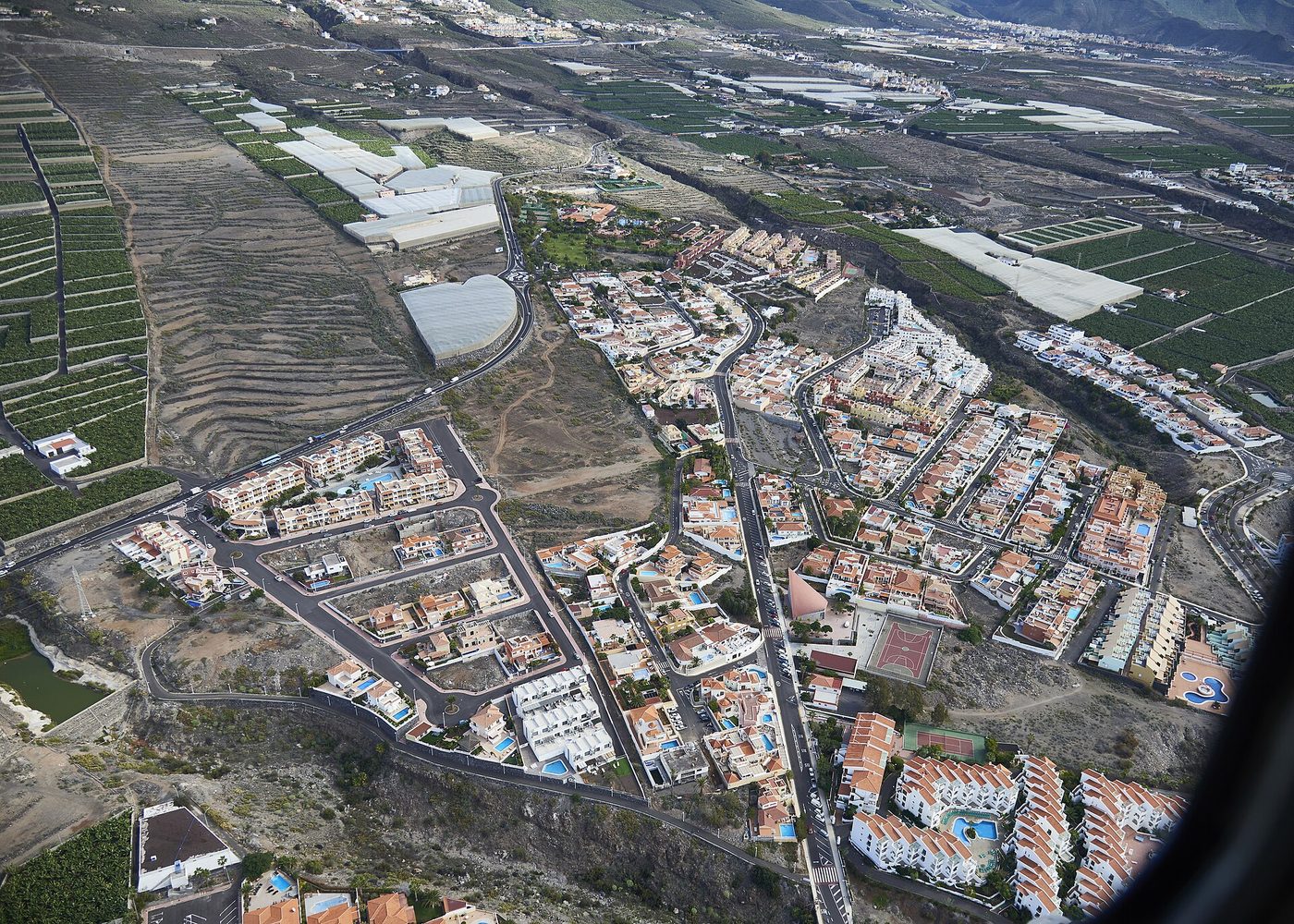 Apartment complexes among banana plantations and old terraces